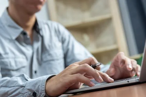 Close up man working and typing on laptop computer keyboard Work from home of 스톡 사진