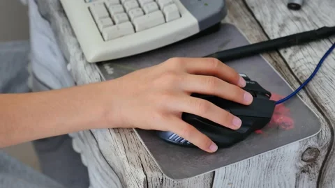 Close-up of a man working with a computer mouse, 스톡 동영상 136035519