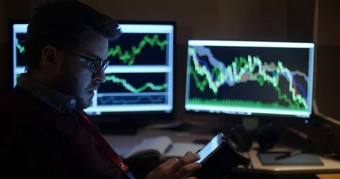 Close up of a man working concentrated with his tablet and graphs2 Stock Footage 88060641