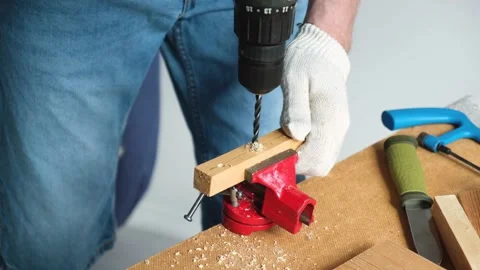 Close-up of man working with drill.A skilled person makes holes in wooden planks Stock Footage 152000980