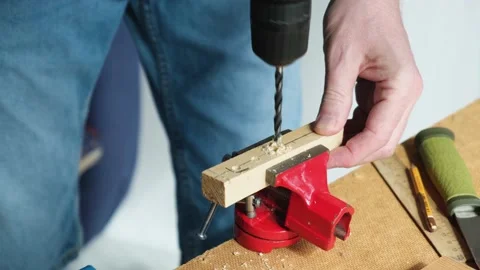 Close-up of man working with drill.A skilled person makes holes in wooden planks Stock Footage 153184104