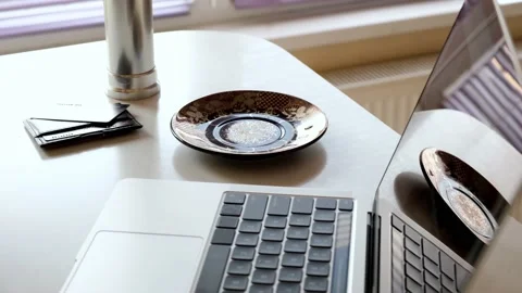 Close-up of a man working on a laptop and drinking morning hot coffee in th.. Stock Footage 236705062