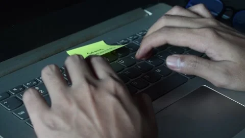 Close up man working with this laptop and get motivation sticky note with wor Stock Footage 287783119
