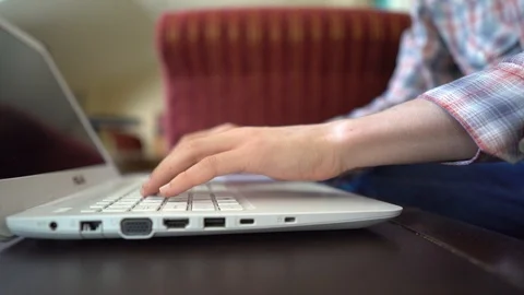 Close-up of a man working on a laptop in coffeehouse Stock Footage 108863509