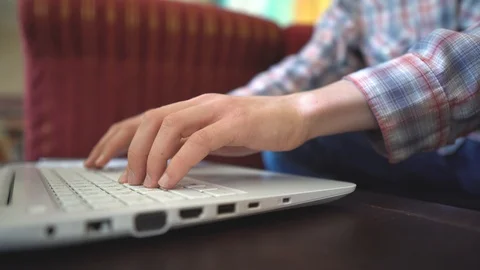 Close-up of a man working on a laptop in coffeehouse Stock Footage 108863559