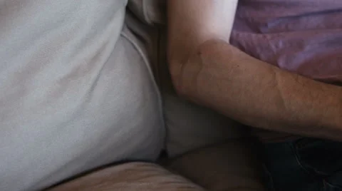 Close up of man working with laptop computer and sitting on sofa at home Stock Footage 65970123