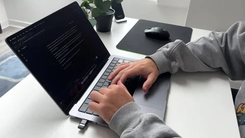 Close-Up of Man Working on MacBook Laptop Interacting with ChatGPT AI Assistant Stock Footage 317355573