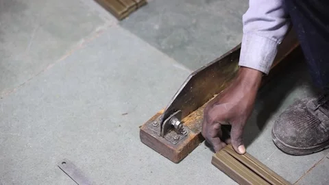 Close up of man working a raw material cutting machine, industrial safety first Stock Footage 297188352