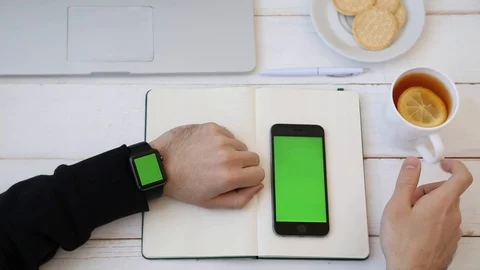 Close up of Man Working Using Smartwatch Connected to Phone. Stockbeeldmateriaal 116613893