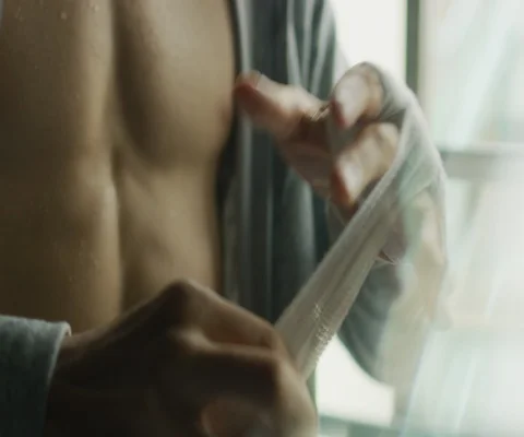 Close up of man wrapping up his hand with bandage with blurry background Stock Footage 147041877