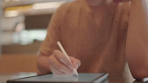 Close-up of a man writing a diary in a coffee shop Stock Footage 251974070