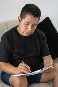 Close up of man writing with missing pinky finger showing focus and everyda.. Photos
