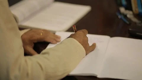 Close up of a man writing on a notebook with pen Guwahati Assam 4k file 13 Stock Footage 339268093