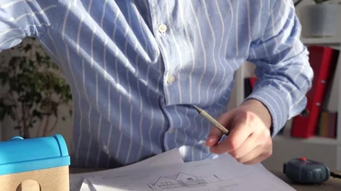 Close-up of a manager showing a plan or drawing of a construction project Stock Footage 306543168
