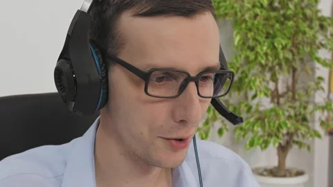 Close-up of the manager wear wireless headset having distance webcam chat job Stock Footage 146790698