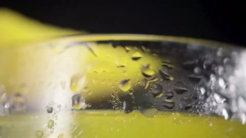 Close Up of Mango Fizzy Drink Pouring in a glass with a Mango Wedge Stock Footage 146560876
