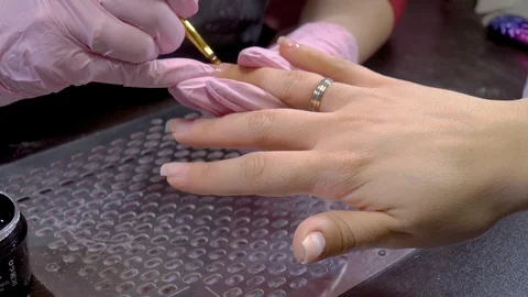 Close up manicure master applying gel base on the nails of the client Stock Footage 103732696