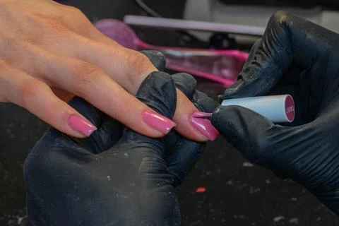 Close-up manicure process, female hands painting nails Stock Photos
