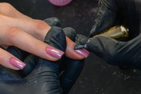 Close-up manicure process, female hands painting nails Stock Photos