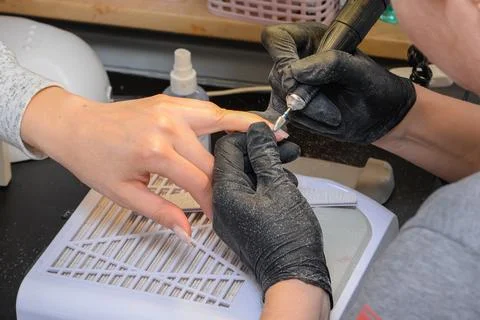Close-up manicure process, female hands painting nails Stock Photos