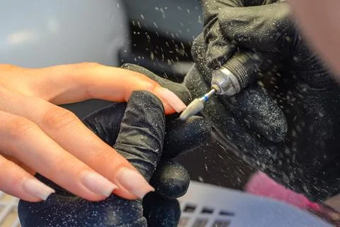 Close-up manicure process, female hands painting nails Stock Photos