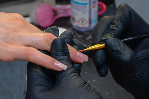 Close-up manicure process, female hands painting nails Stock Photos