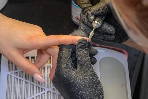 Close-up manicure process, female hands painting nails Stock Photos