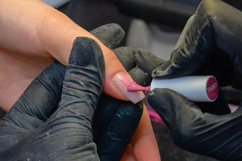Close-up manicure process, female hands painting nails Stock Photos