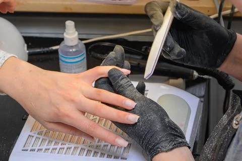 Close-up manicure process, female hands painting nails Stock Photos