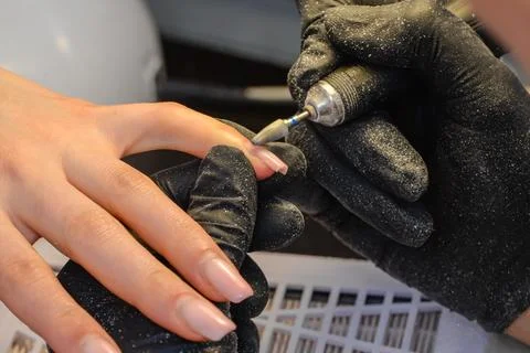 Close-up manicure process, female hands painting nails Stock Photos