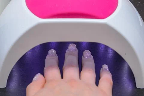 Close-up manicure process, female hands painting nails Stock Photos