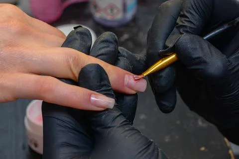 Close-up manicure process, female hands painting nails Stock Photos