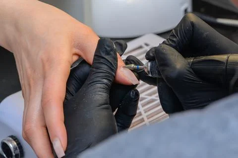 Close-up manicure process, female hands painting nails Stock Photos