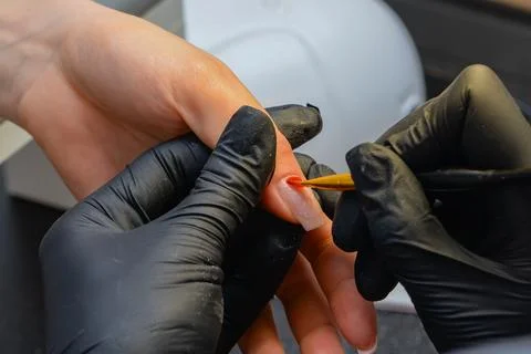 Close-up manicure process, female hands painting nails Stock Photos