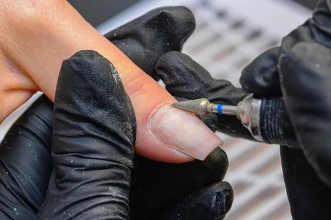 Close-up manicure process, female hands painting nails Stock Photos