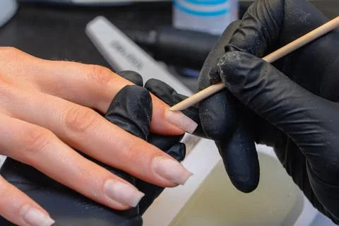 Close-up manicure process, female hands painting nails Stock Photos