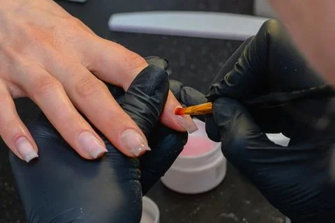 Close-up manicure process, female hands painting nails Foto stock