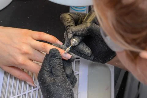 Close-up manicure process, female hands painting nails Foto stock
