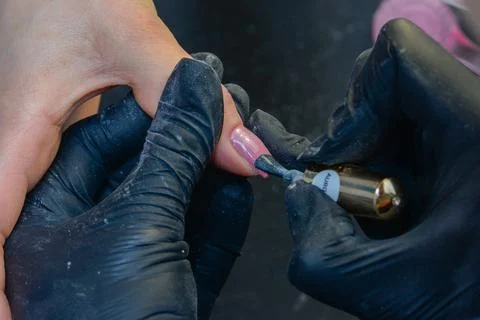 Close-up manicure process, female hands painting nails Stock Photos