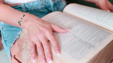 Close-Up of Manicured Hand Caressing Book Pages, 4K Stock Footage 273236685