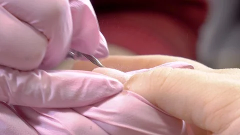 Close up manicurist remove cuticles using electric file nail drill Stock Footage 103339180