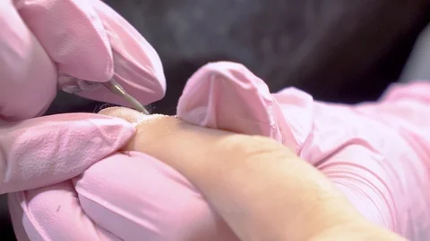 Close up manicurist remove cuticles using electric file nail drill Video stock 103732166