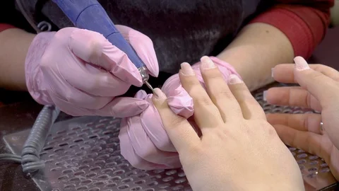 Close up manicurist remove cuticles using electric file nail drill Stock Footage 103732370