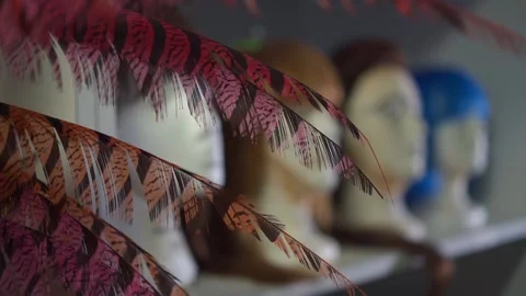 Close-up mannequin heads with makeup faces in row on shelf of dressing room,blue Stock-Footage 166874602