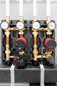 Close up of manometer, pipe, flow meter, water pumps and valves of heating sy Foto stock