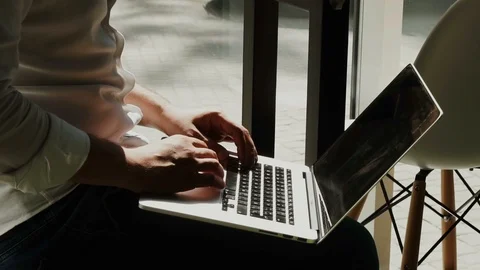 Close-up of man's arms working on laptop Stock Footage 112986407