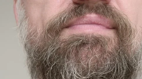 Close up of man's bearded face. Man smiles and shows his teeth with fillings Stock Footage 134965304