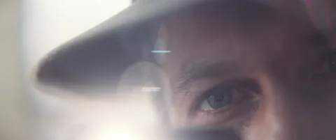 Close up of a man's blue eyes while light flares move around Stock Footage 202249103