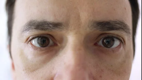 Close up of man's brown eyes blinking slowly Stock Footage 344278140