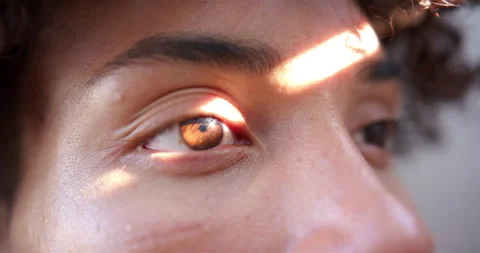 Close-up of man's eye with sunlight reflecting, showing detailed iris pattern Stock Footage 300071522